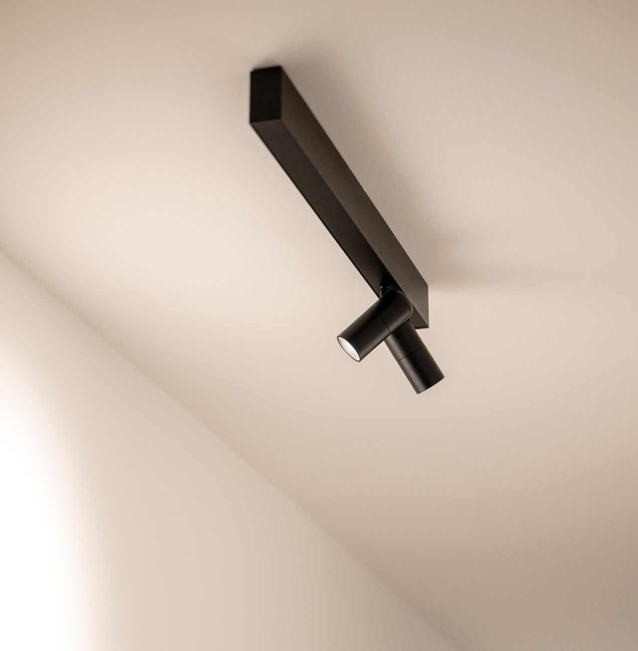 Minimalistische zwarte plafondspot als accentverlichting